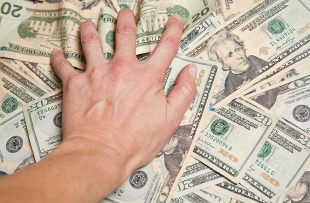 Classic mlm image showing a persons hand grabbing money