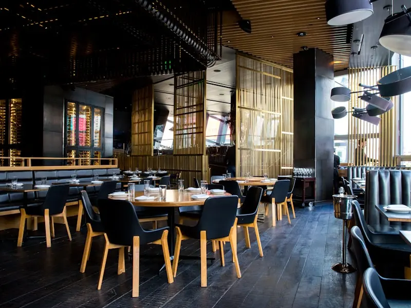 This is a restaurant with wooden chairs and black back rests